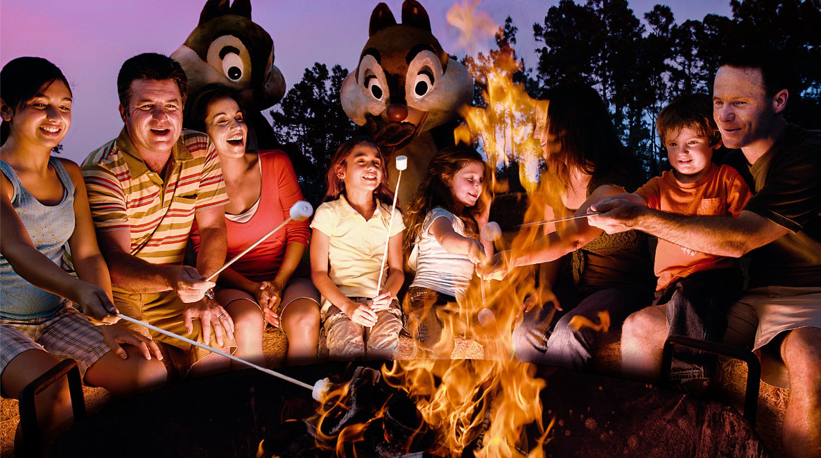 family at a campfire with chip and dale